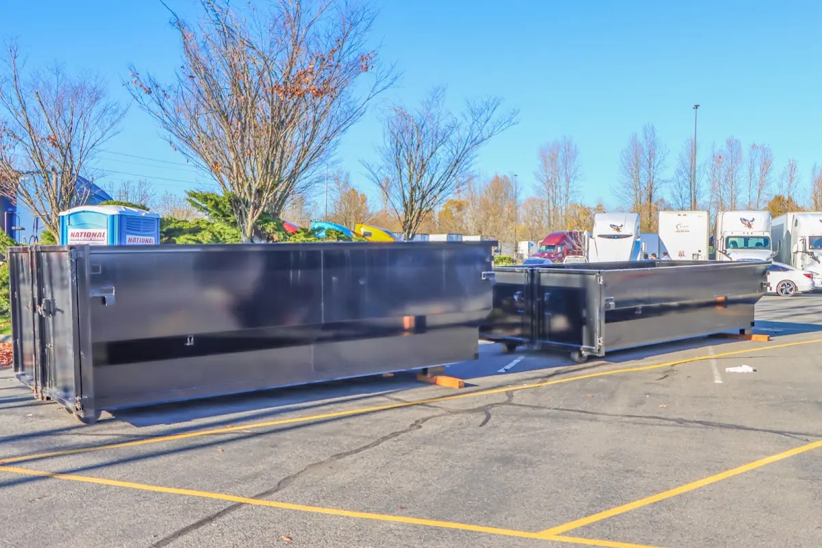 Professional dumpster rental service with roll-off container on residential driveway in Gypsum